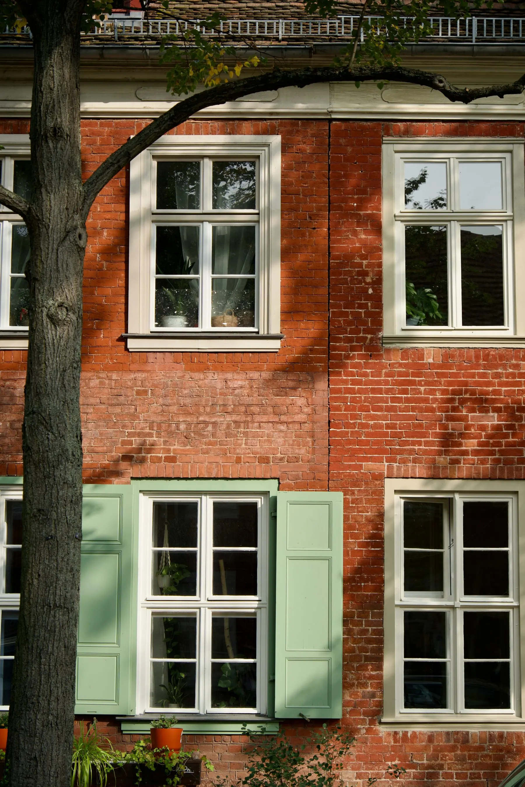 Sanierte Klinkerfassade mit grünen Fensterläden